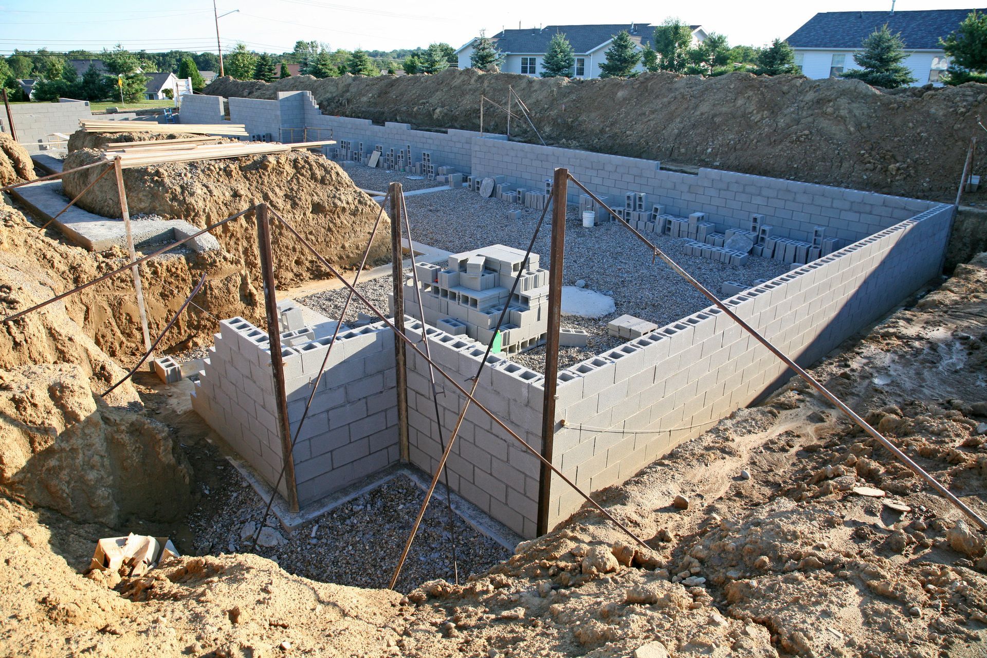 A brick wall is being built in a construction site