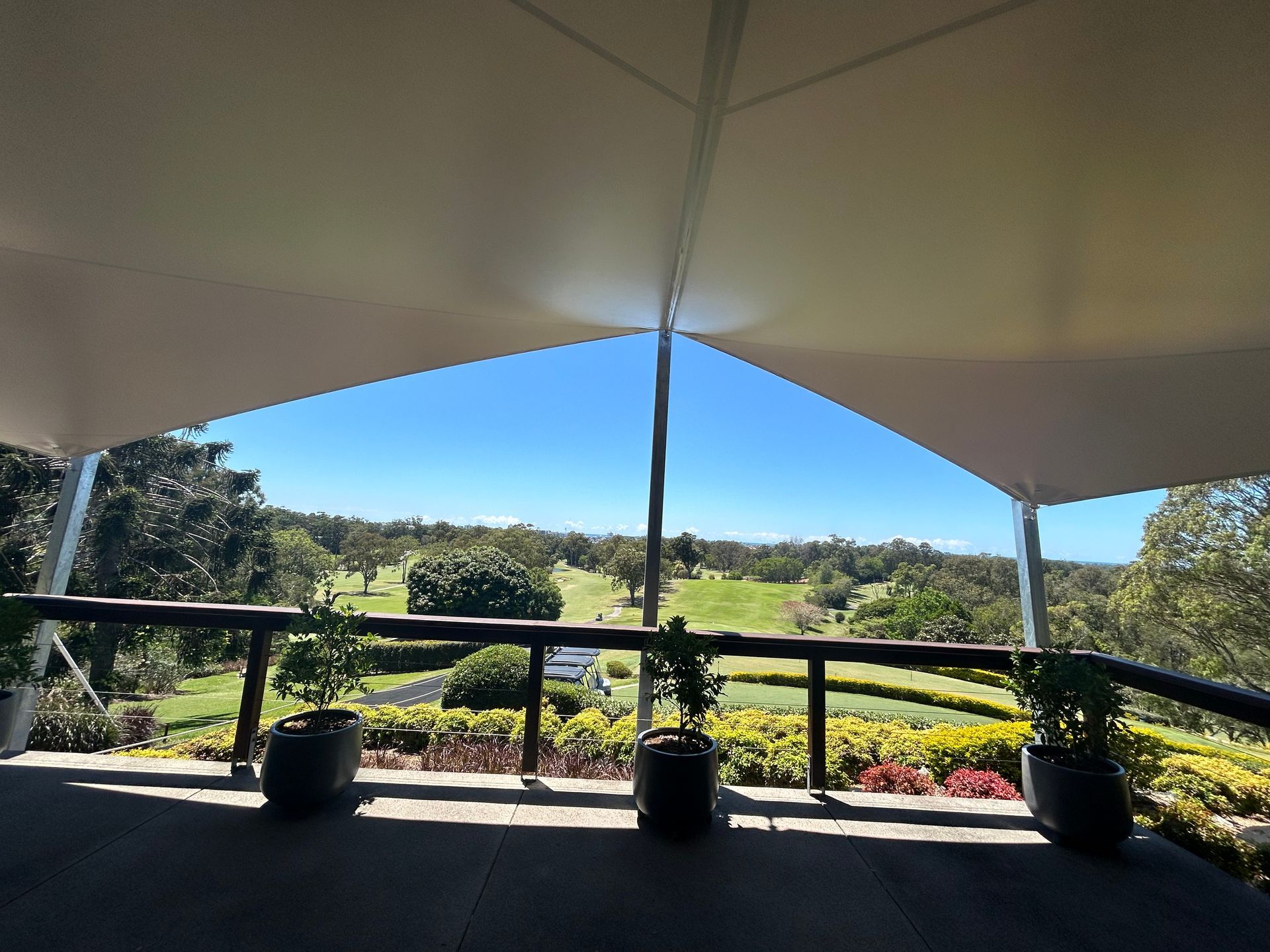 A Cream Shade Sail Overlooking A Golf Course— Sunshine Shade & Sails In Woombye, QLD