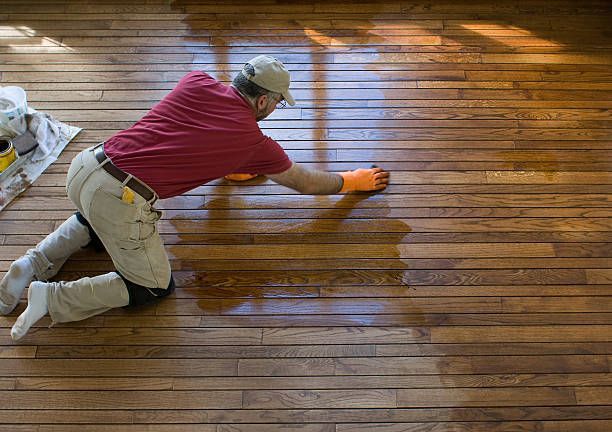 A person cleaning a light-colored carpet with a professional cleaning machine.