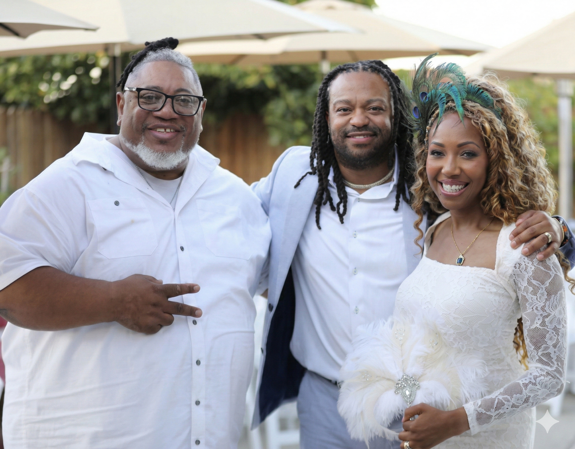 A man in a tuxedo is taking a selfie in front of a speaker