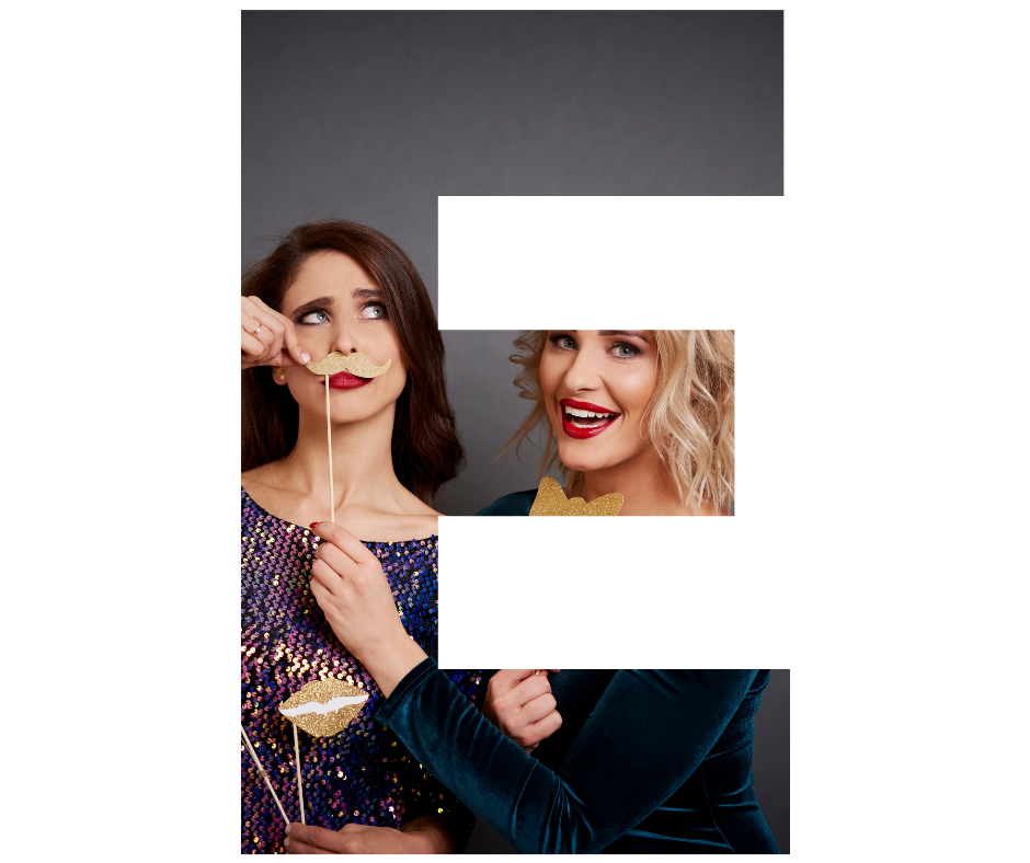 A group of people are taking a picture of themselves in a photo booth at a party.