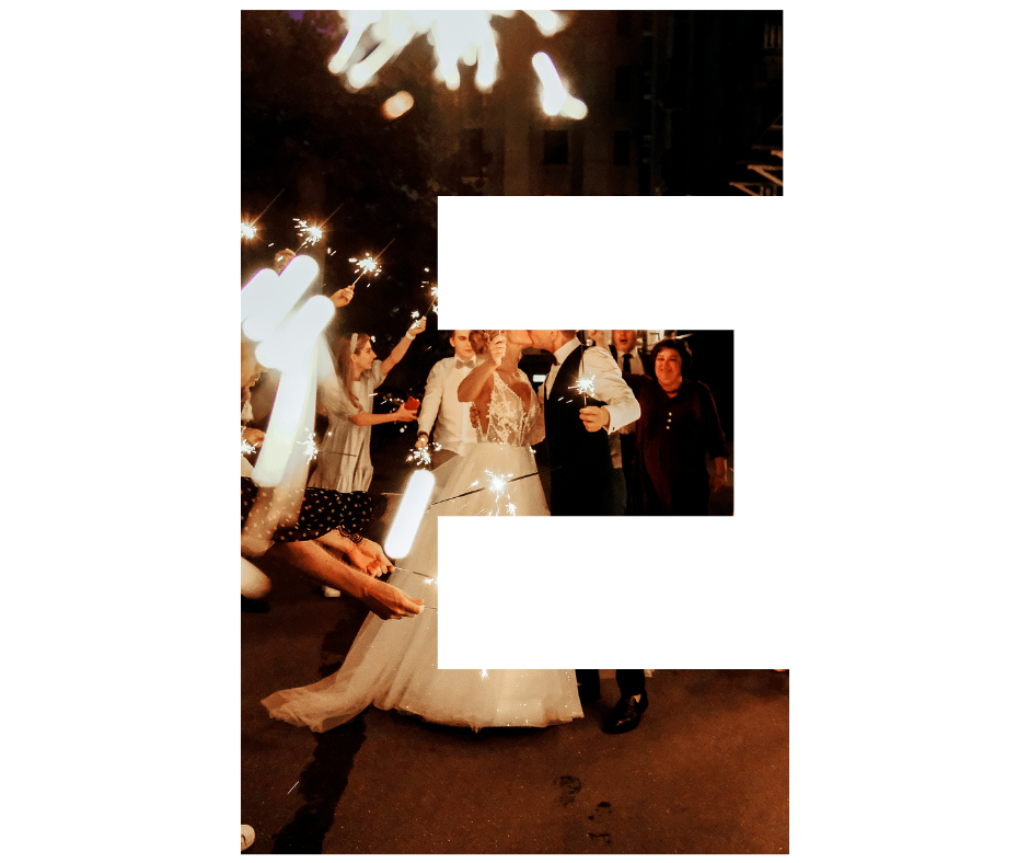 A group of people are standing around a bride and groom at a wedding reception.