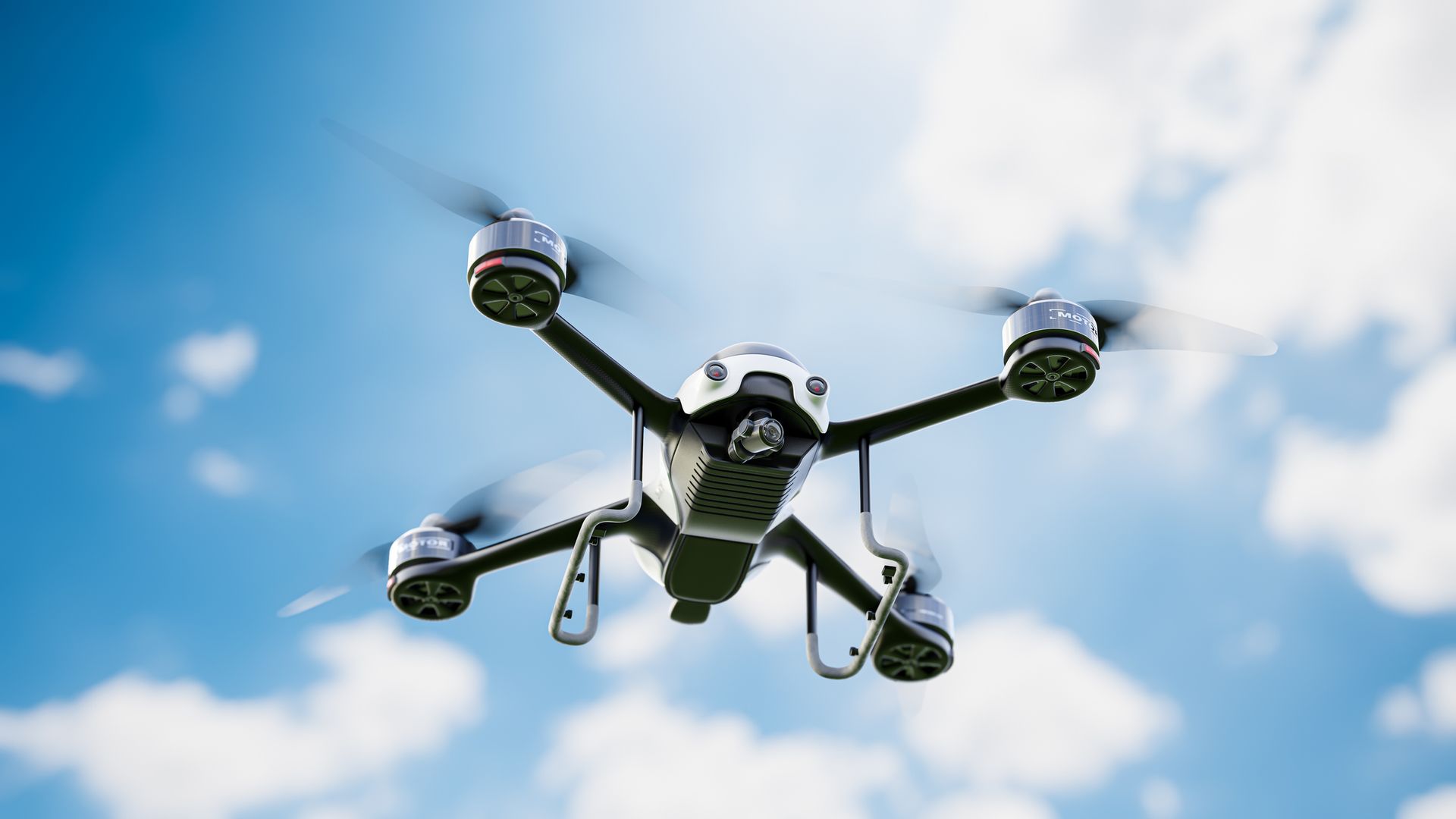 Drone che vola in un cielo azzurro con nuvole bianche.