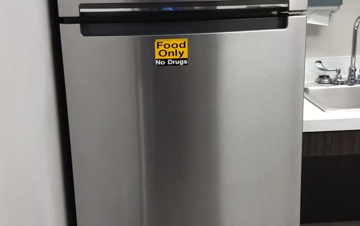 A stainless steel refrigerator with a food only sticker on it