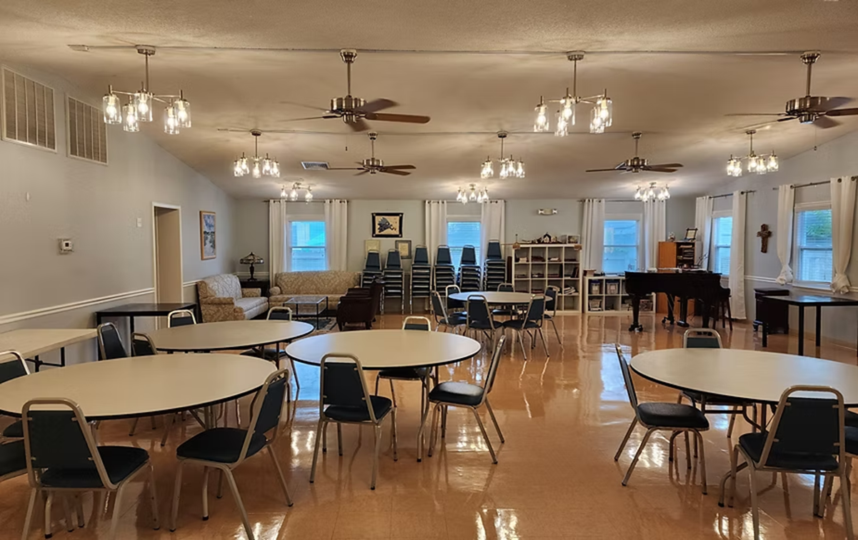 A large room with tables and chairs in it.