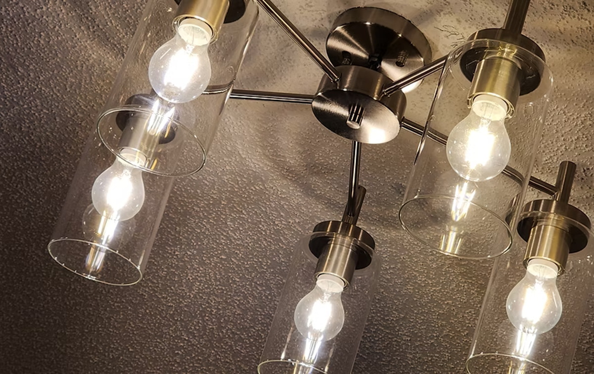 A close up of a ceiling light with clear glass shades