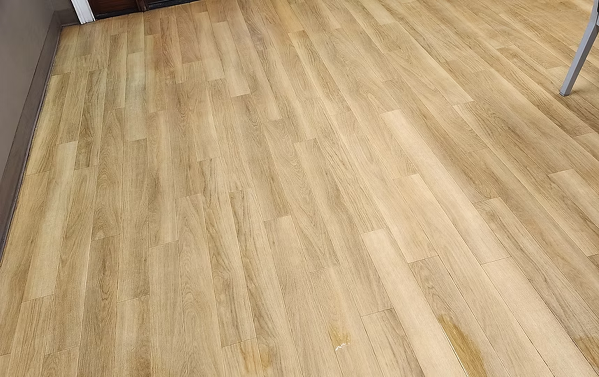A close up of a wooden floor in a room.