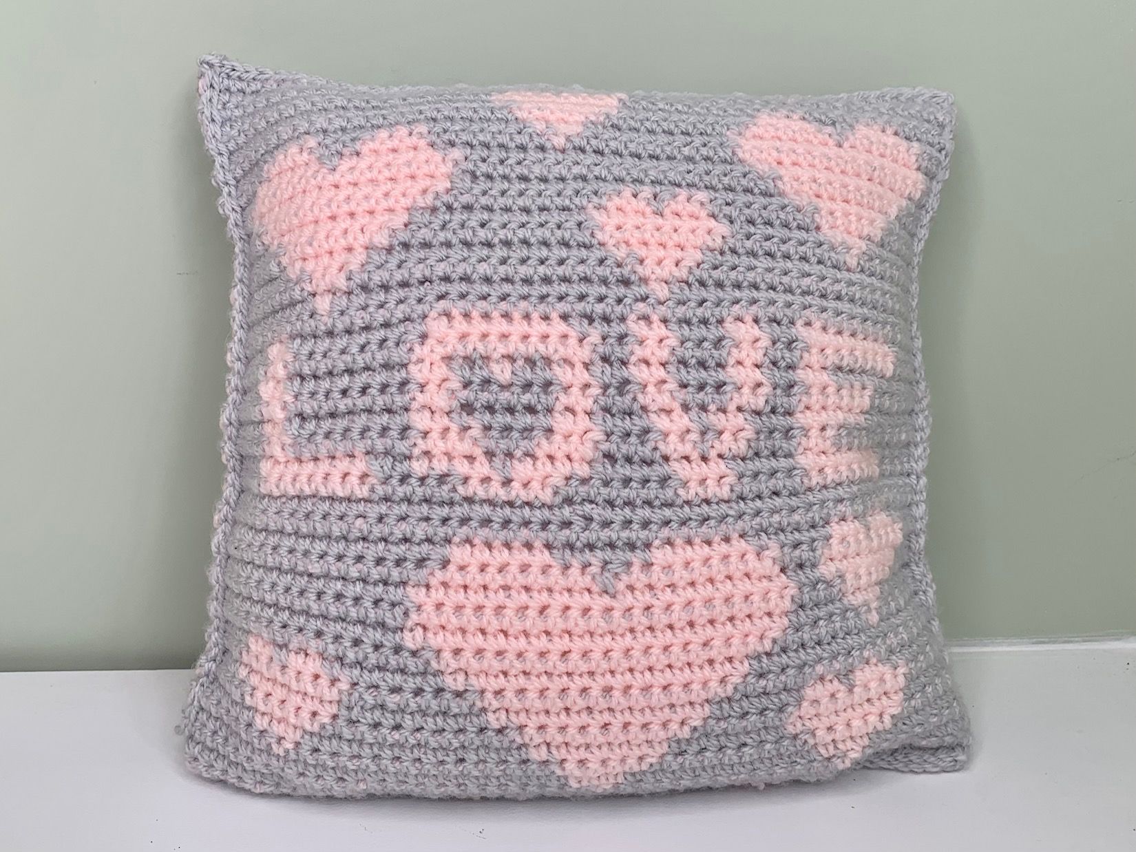 Joining love hearts crochet cushion