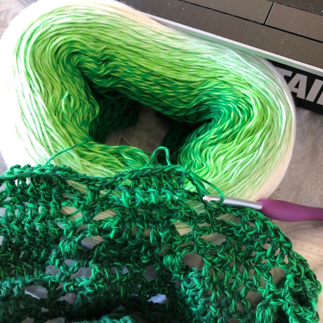 Yarn cake in use to create a twisted crochet cowl