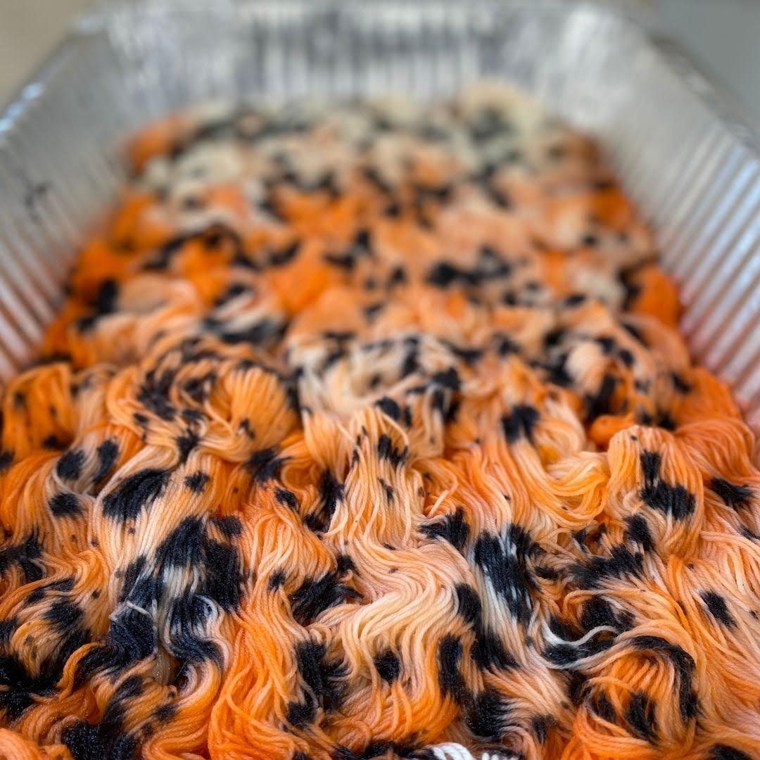 speckled hand dyed yarn in a pan
