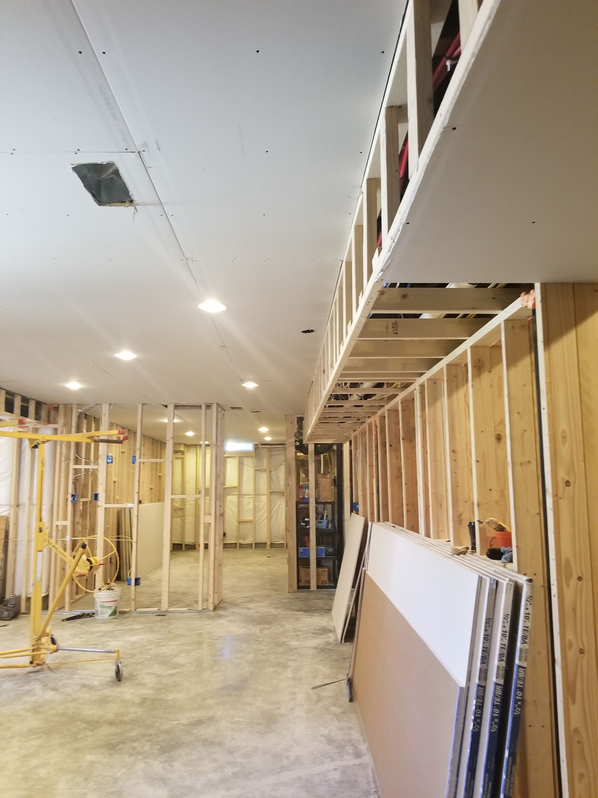 A room under construction with a lot of wooden beams and a ceiling.