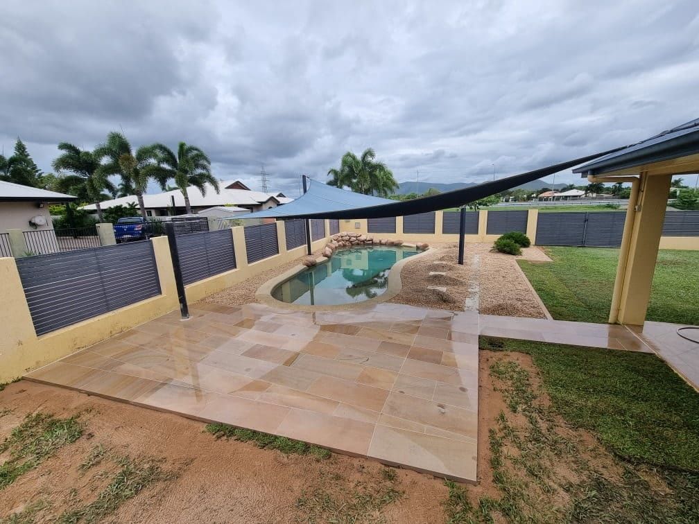 There is a Swimming Pool in the Backyard of a House — Lynams Landscapes Pty Ltd in Kirwan, QLD