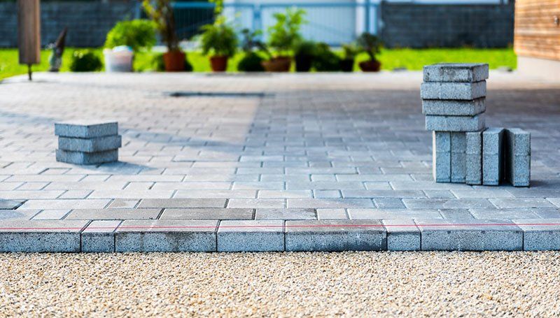 Laying Gray Concrete Paving Slabs — Lynams Landscapes In Jensen QLD