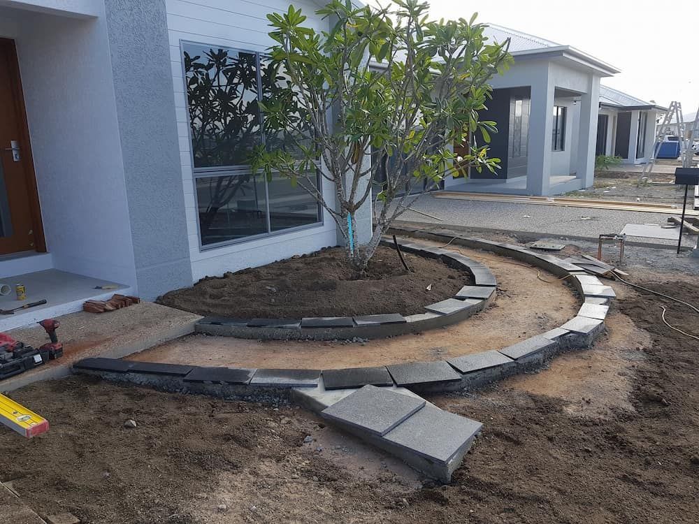 A White House With a Tree in Front of It is Being Built — Lynams Landscapes Pty Ltd in Townsville, QLD