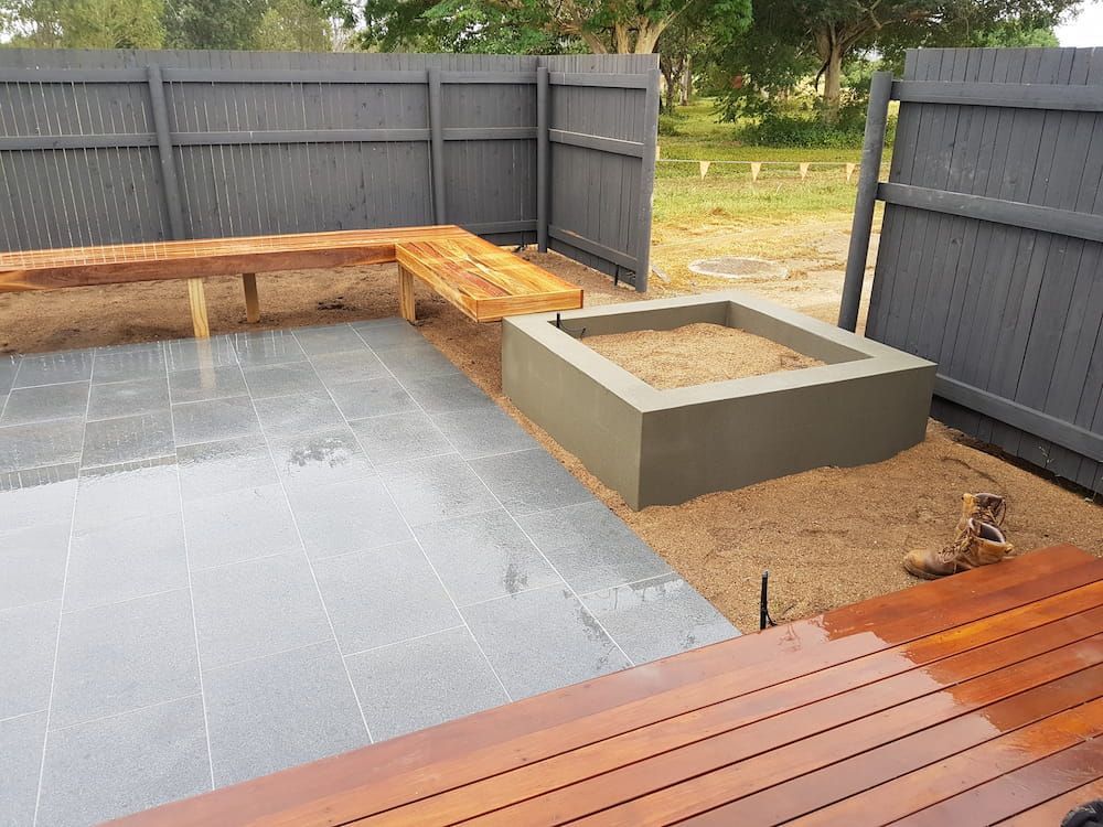 A Wooden Deck With a Sandbox in the Middle of It — Lynams Landscapes Pty Ltd in Jensen, QLD