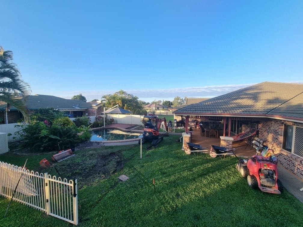 A Lawn Mower is Parked in the Backyard of a House — Lynams Landscapes Pty Ltd in Castle Hill, QLD