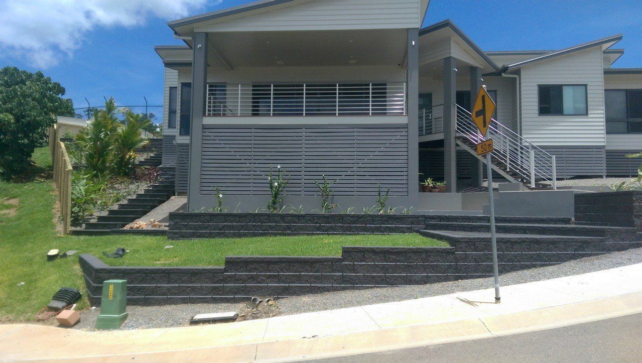 A Large White House With Stairs Leading Up to It — Lynams Landscapes Pty Ltd in Jensen, QLD