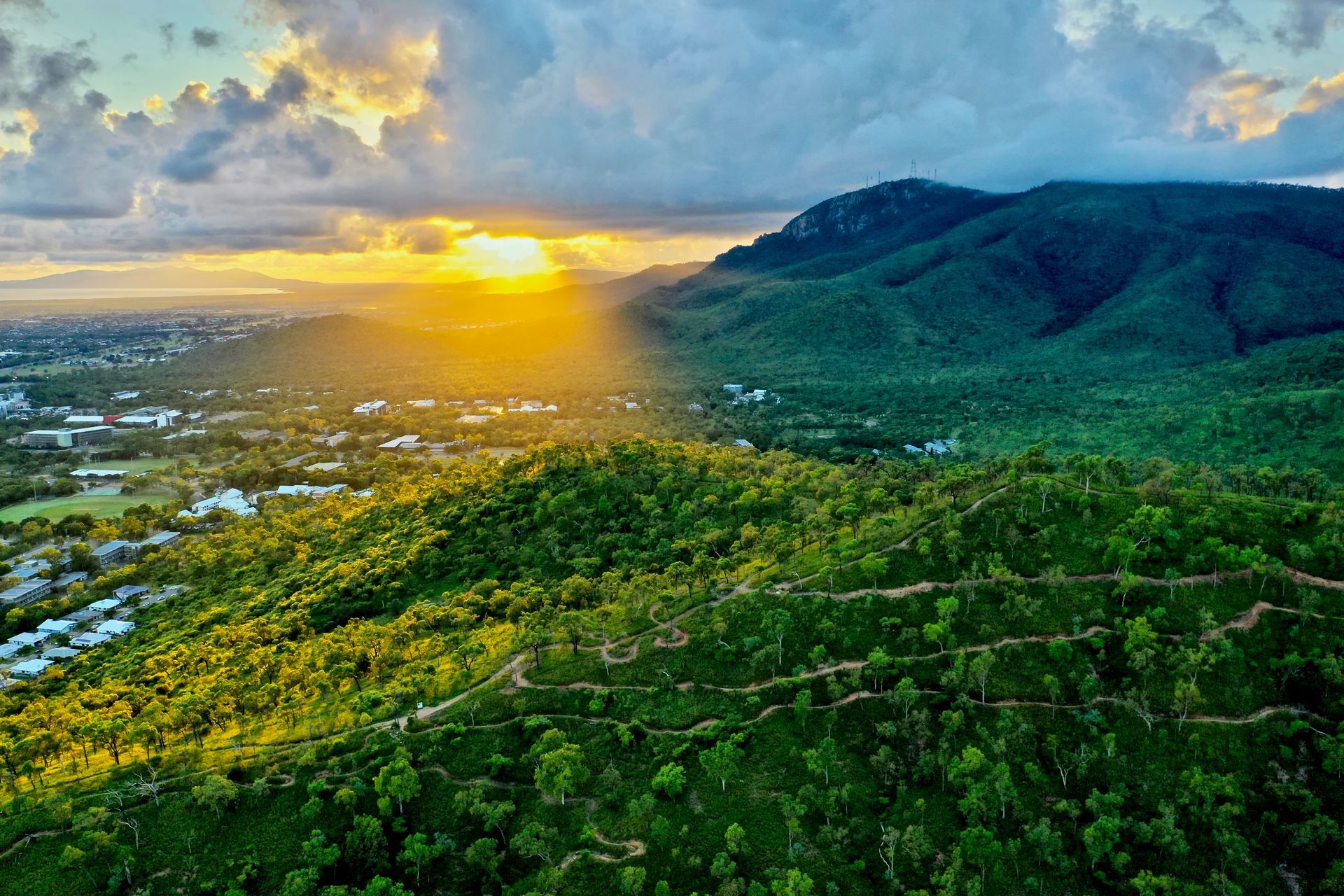 An aerial view of a sunset over a lush green hillside — Lynams Landscapes Pty Ltd in Douglas, QLD