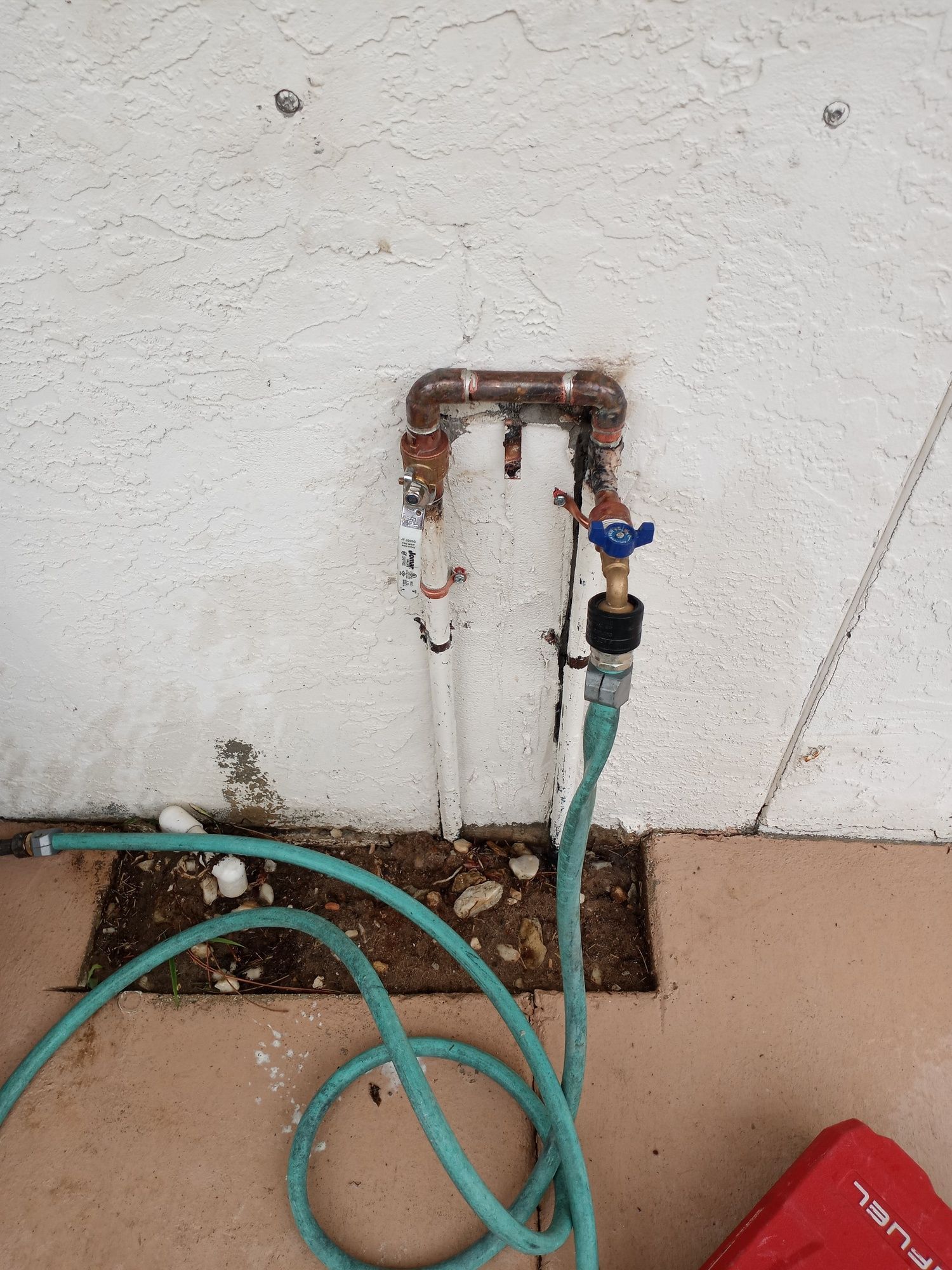 a hose is attached to a faucet on a wall .