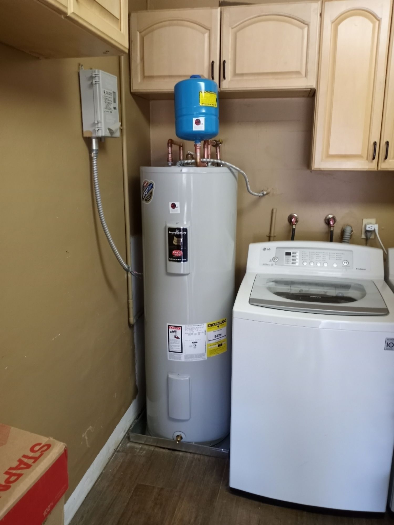 a laundry room with a water heater and a washing machine