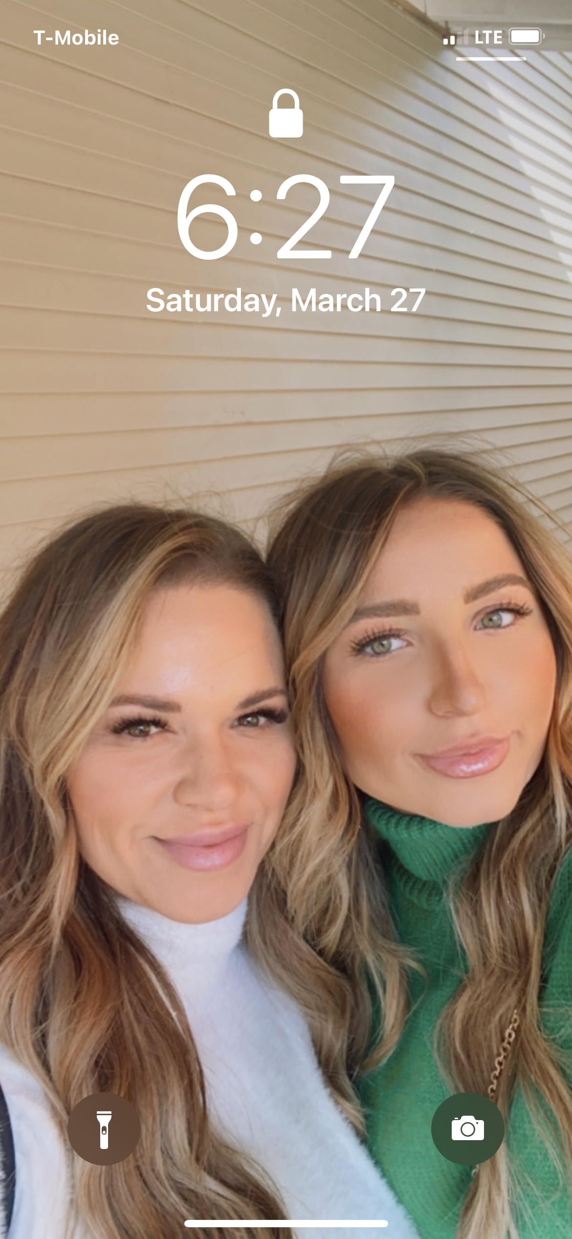 A couple of women standing next to each other on a phone screen.