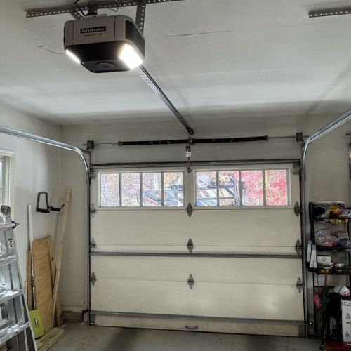 A garage with a garage door open and a garage door opener.