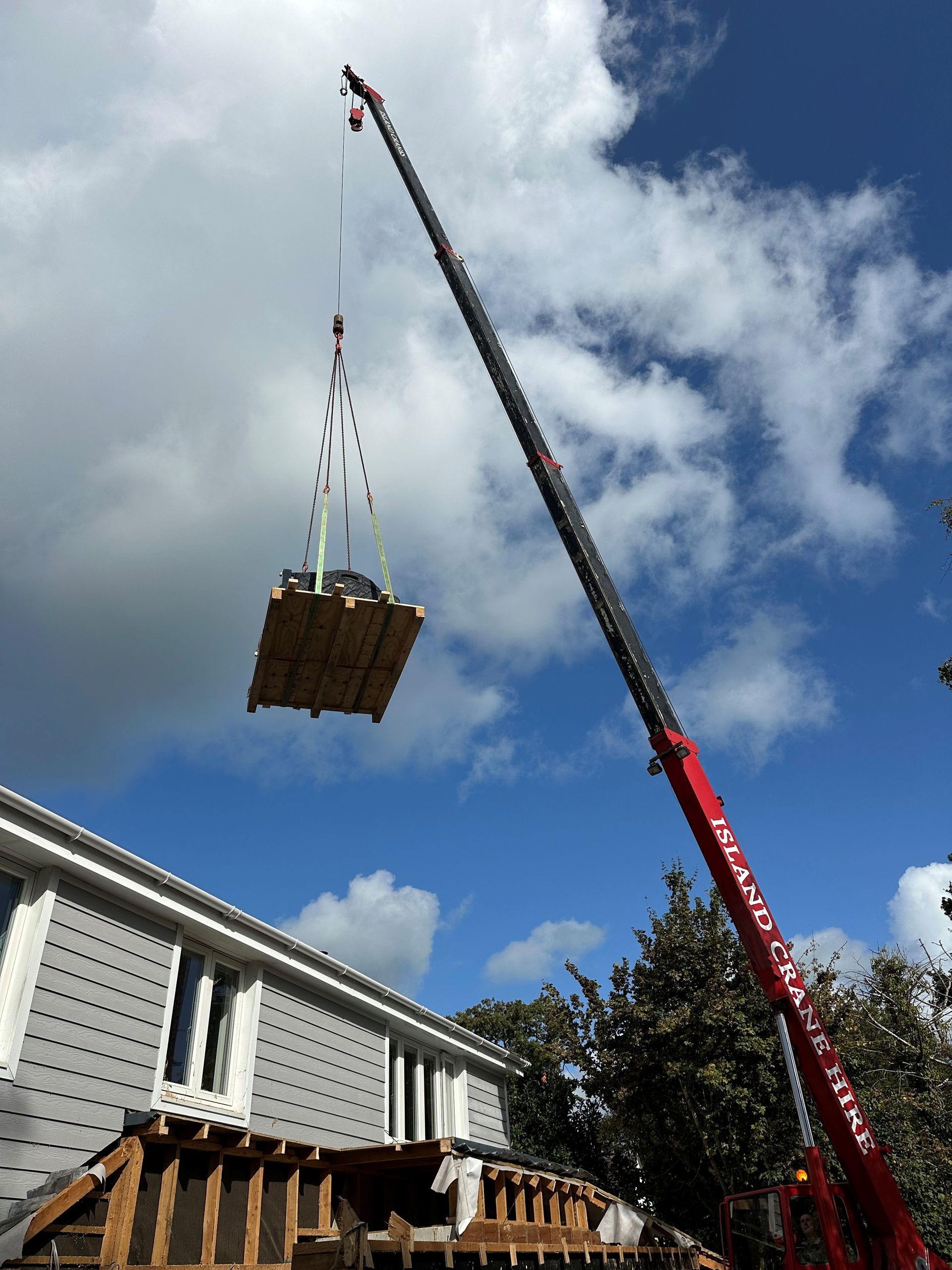 A crane moving a piano at Laceys Removals Isle of Wight