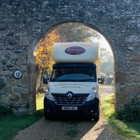 An image of a Laceys Isle of Wight Removals van under a stone arch 