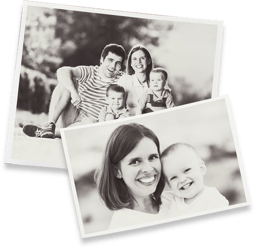 A black and white photo of a family and a woman holding a baby.