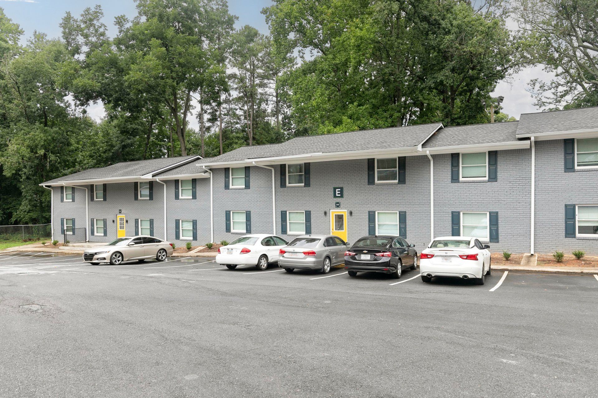 Forest Park, GA Apartments - Gardens at Park West - Parking Lot In Front Of Apartments.
