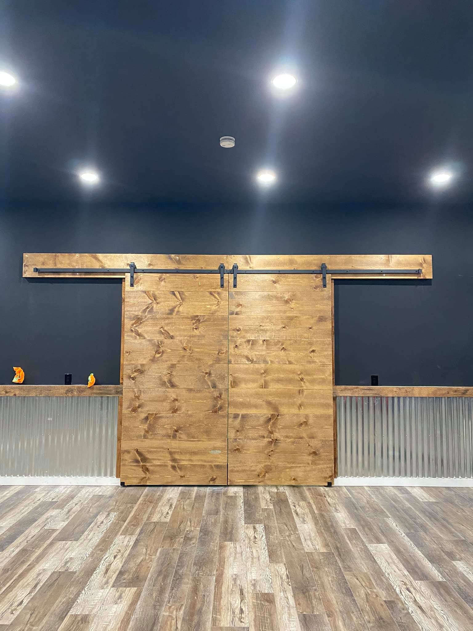 There is a sliding barn door in the middle of the room.