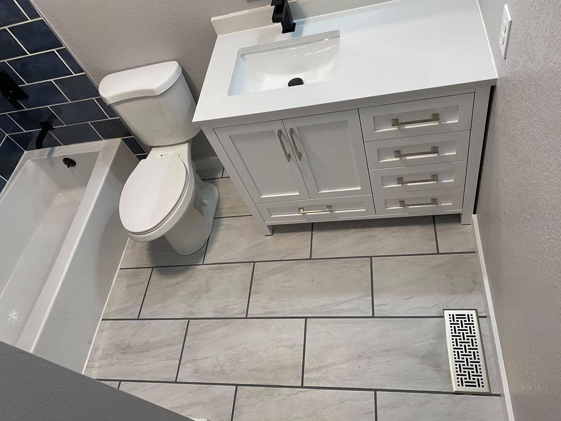 A bathroom with a toilet , sink and bathtub