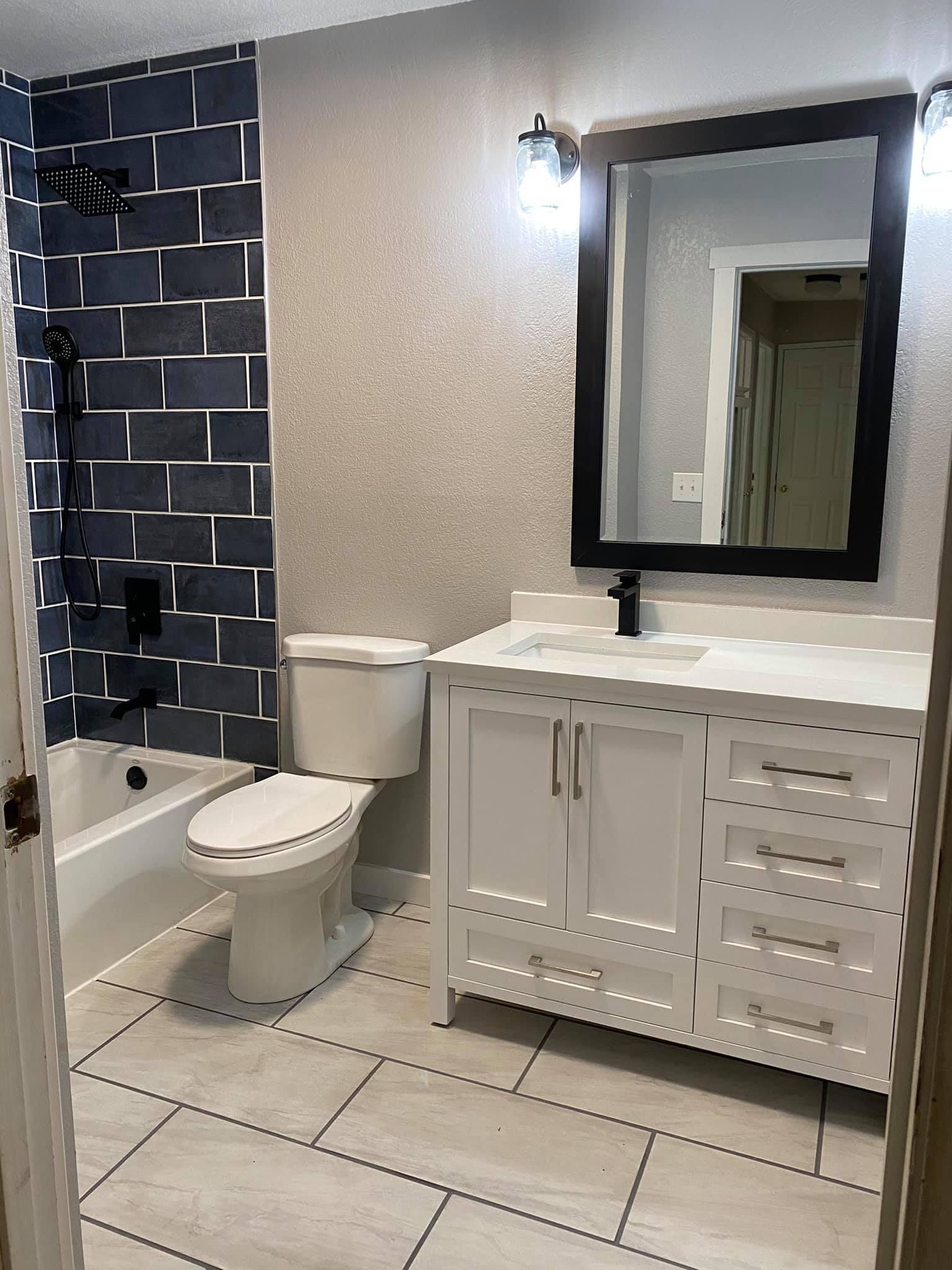 A bathroom with a toilet , sink , and mirror.