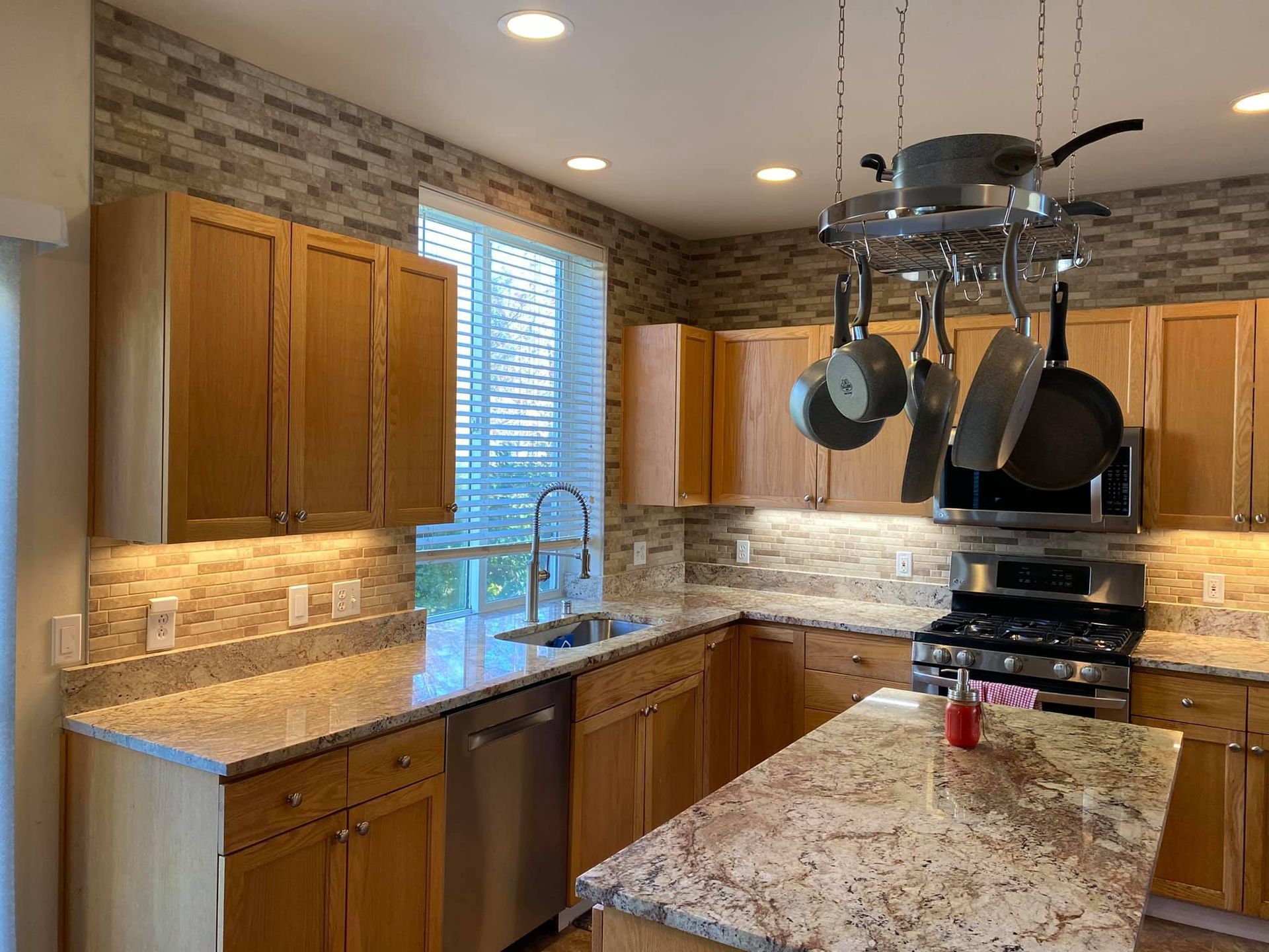 A kitchen with wooden cabinets and granite counter tops