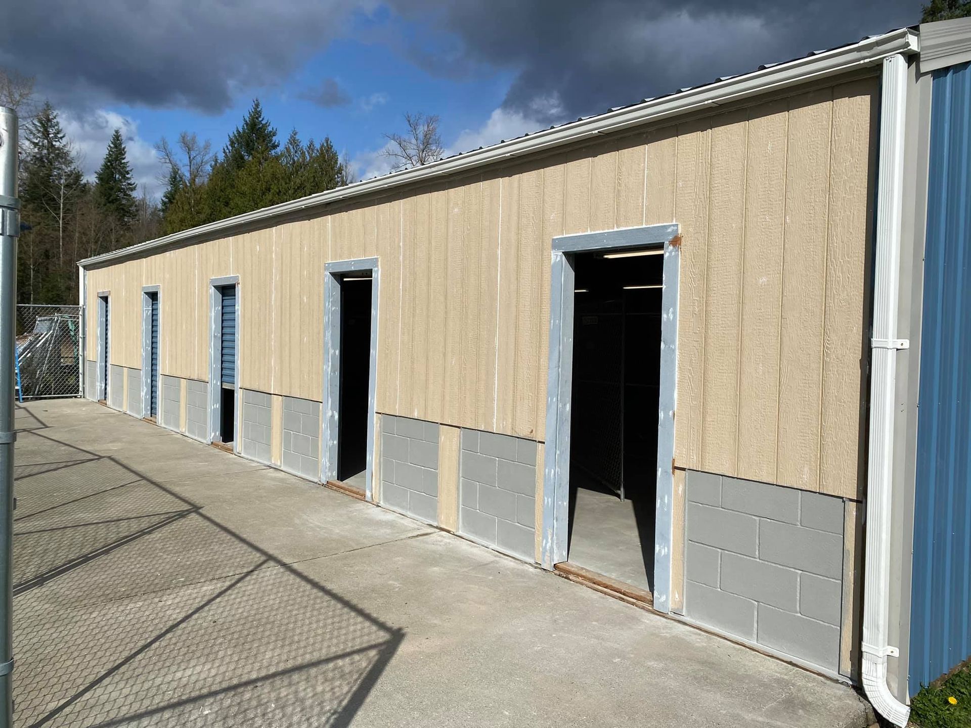 A building with a lot of doors and a drainpipe on the side of it.