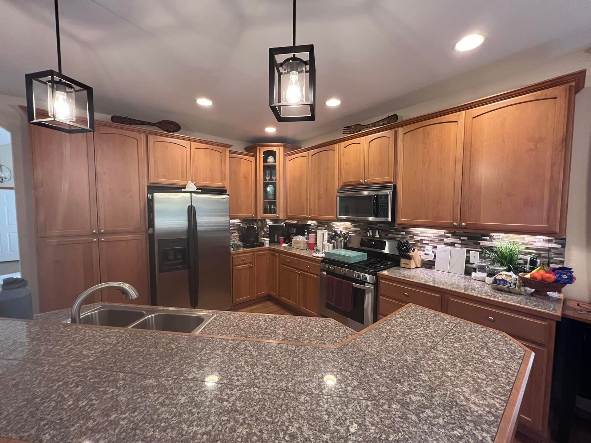 A kitchen with granite counter tops and stainless steel appliances
