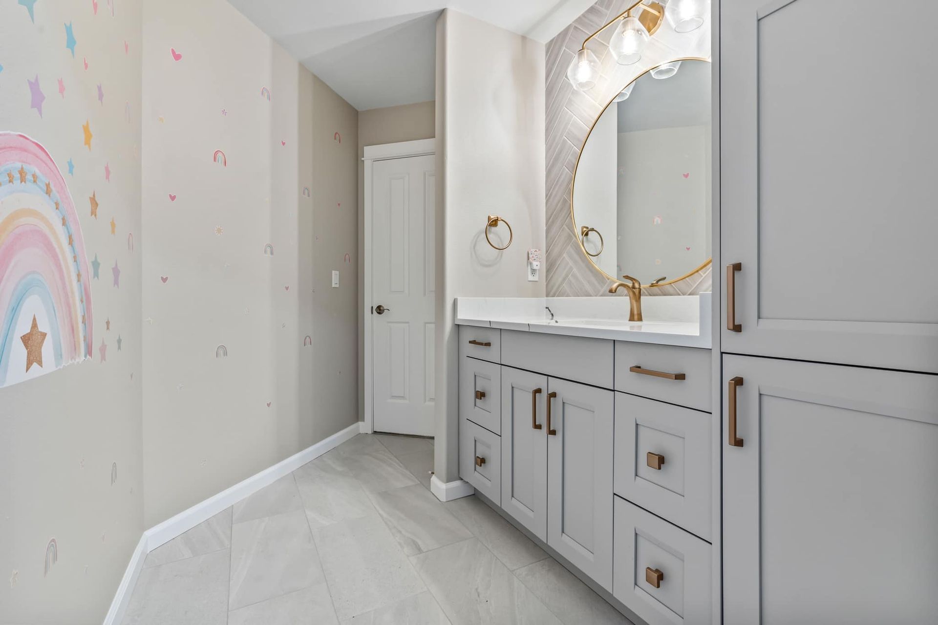 A bathroom with two sinks and a large mirror.