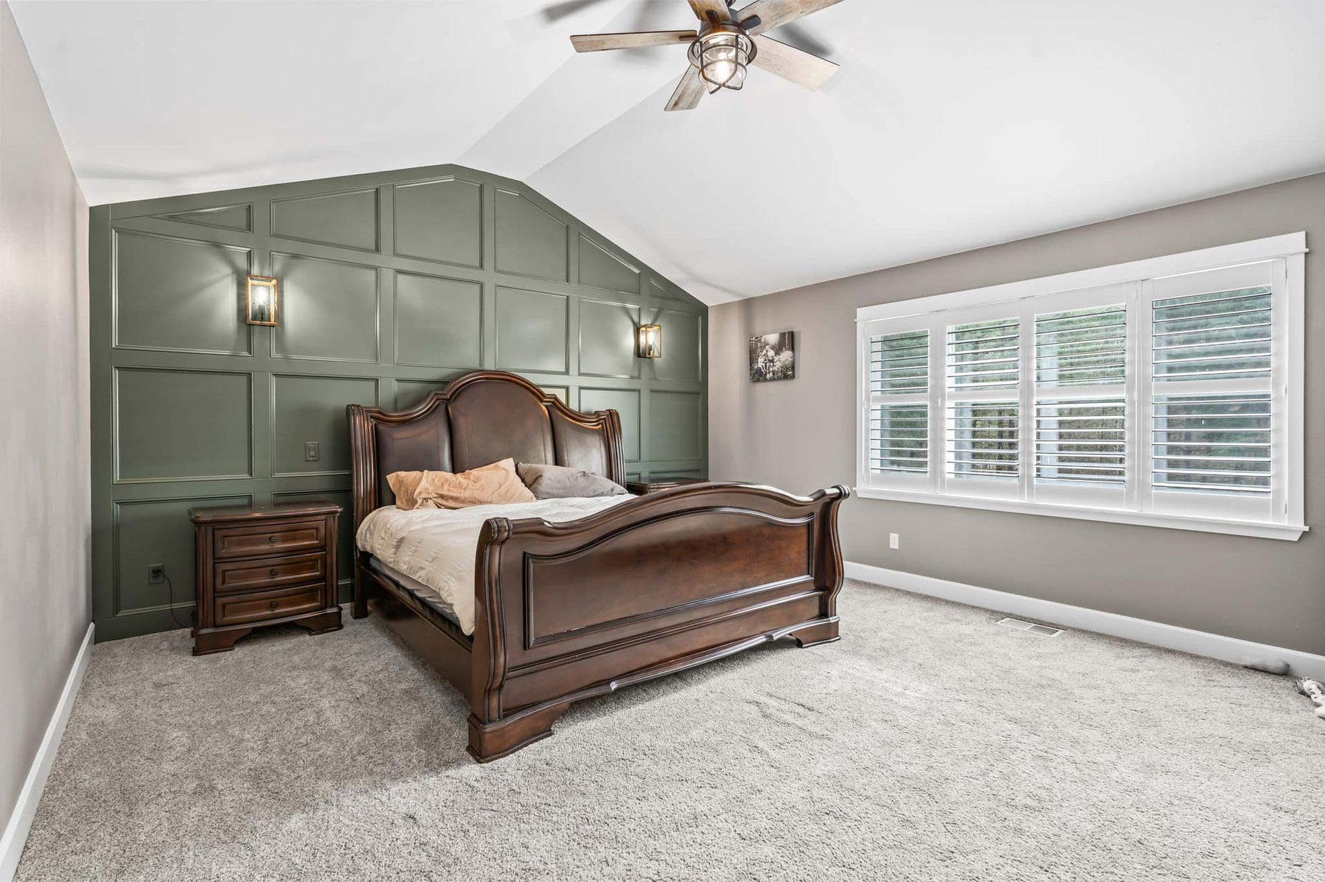 A bedroom with a bed , nightstand , and ceiling fan.