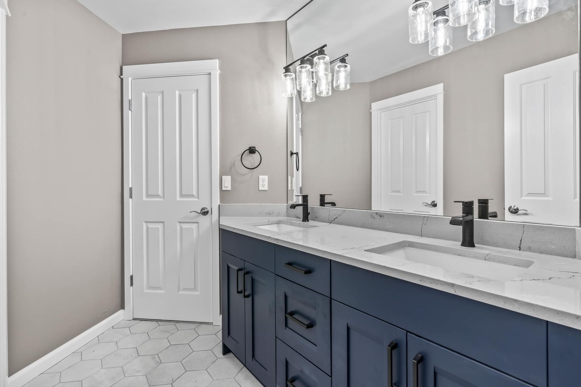 A bathroom with two sinks and a large mirror.