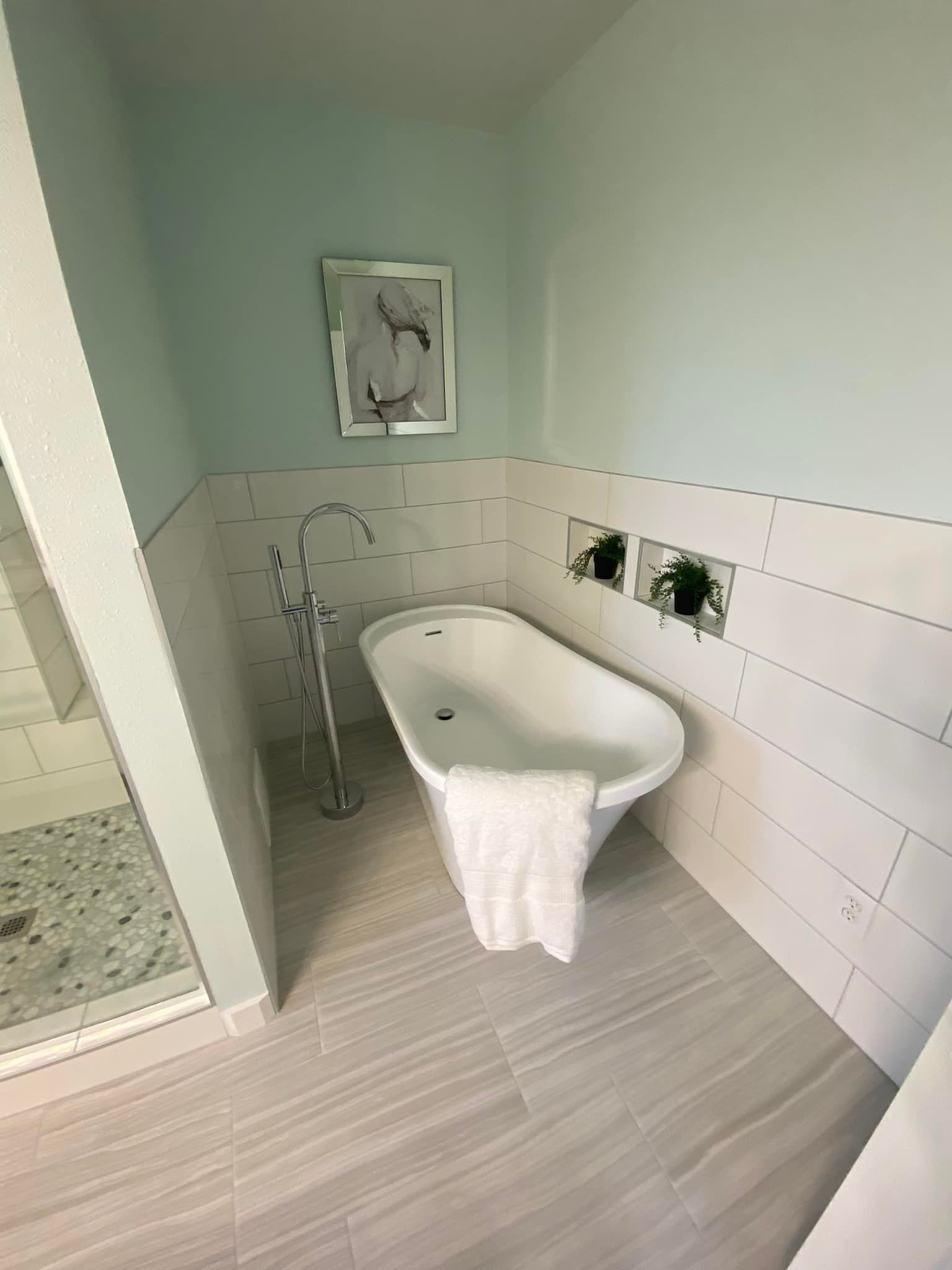 A bathroom with a bathtub and a shower.