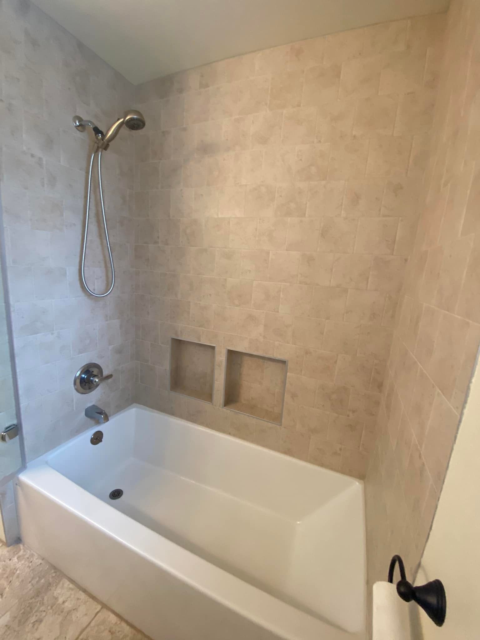 A bathroom with a bathtub and a shower.