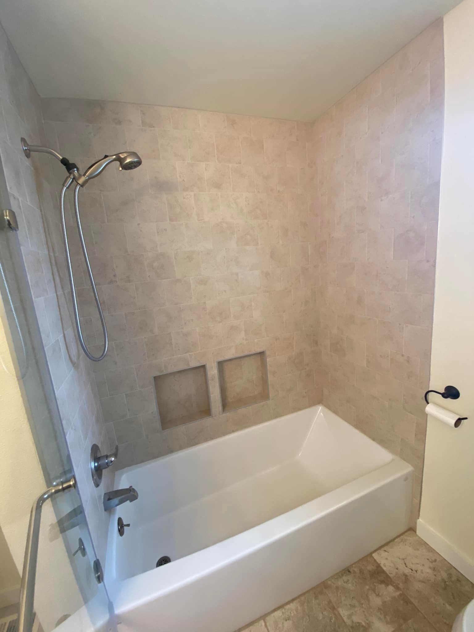 A bathroom with a bathtub and a shower.