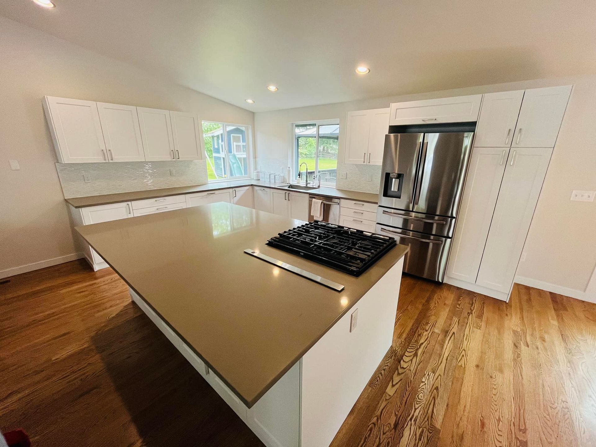 A kitchen with stainless steel appliances and a large island.