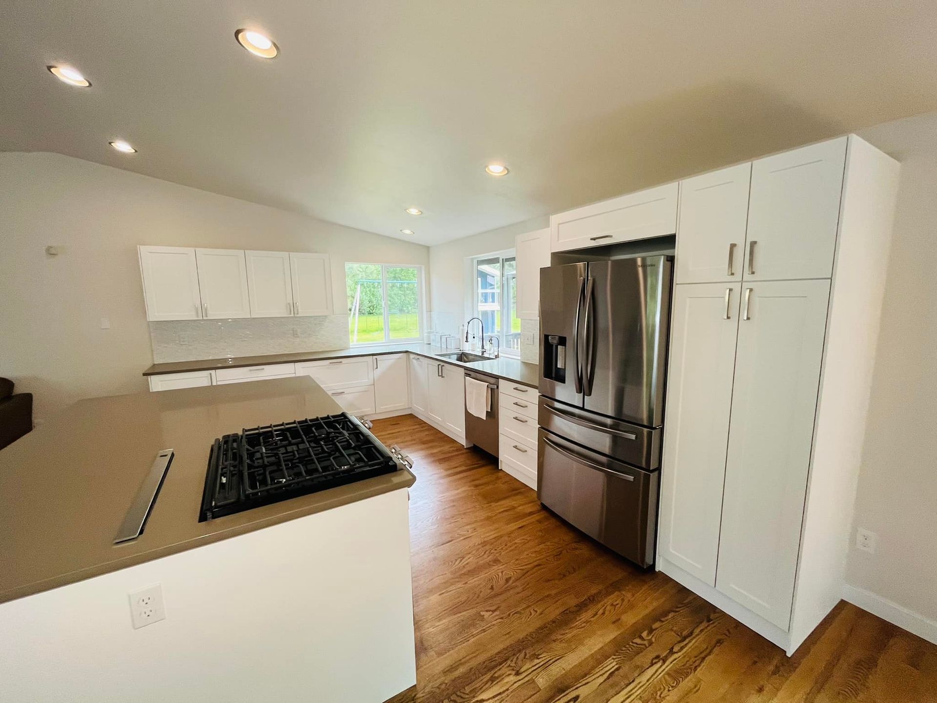 A kitchen with white cabinets and stainless steel appliances.