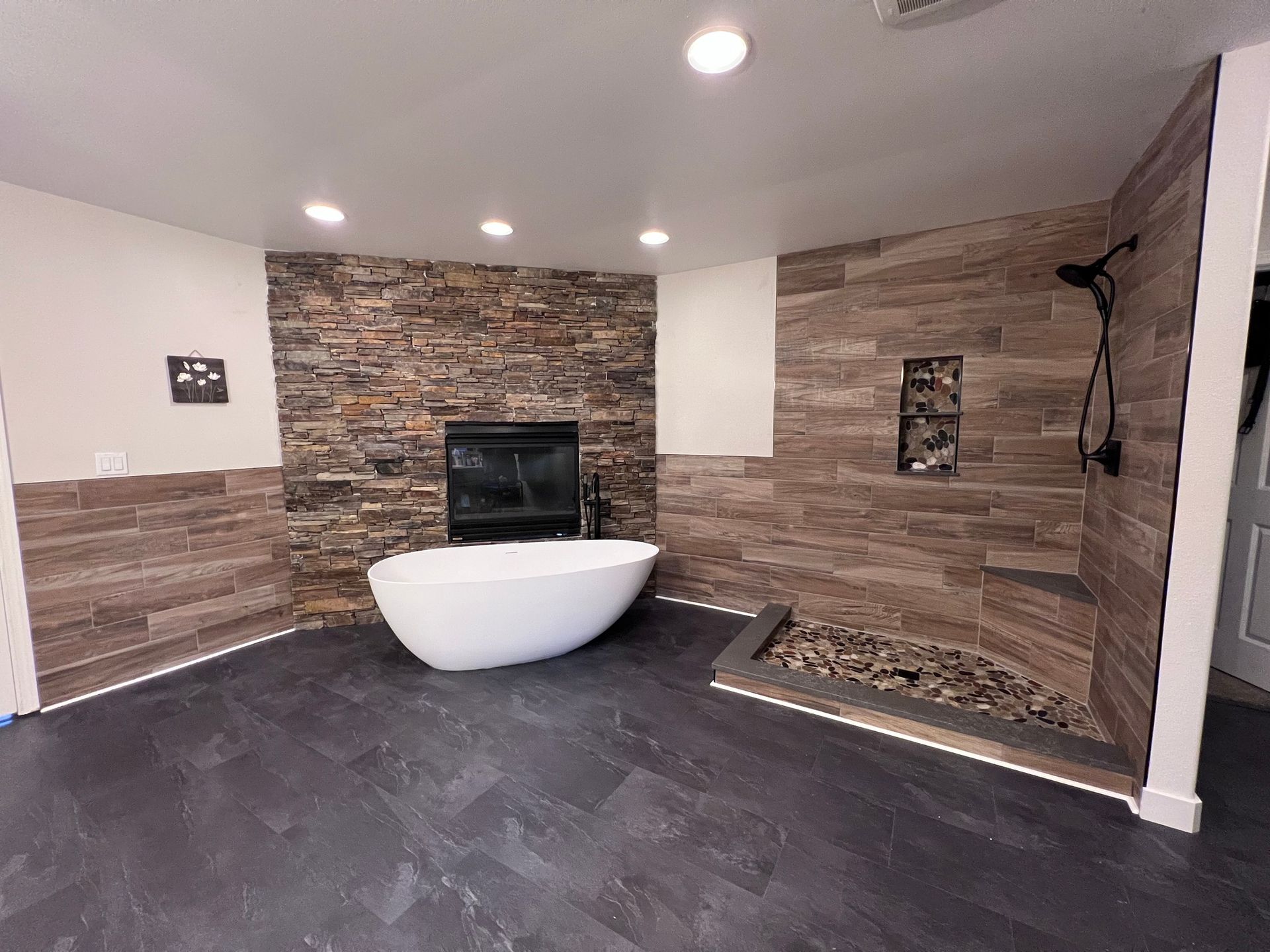 A bathroom with a bathtub and a fireplace.