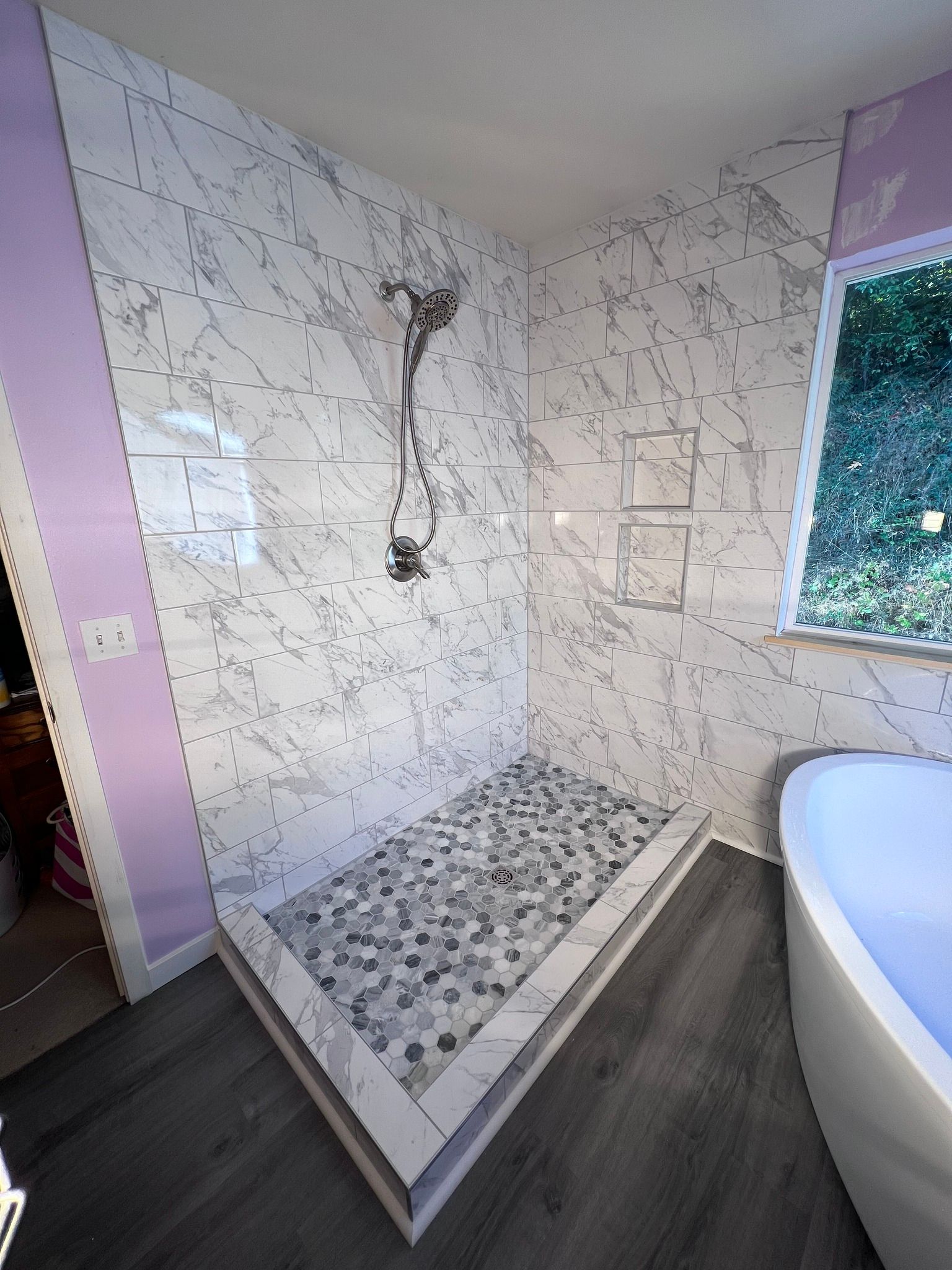 A bathroom with a walk in shower and a bathtub.