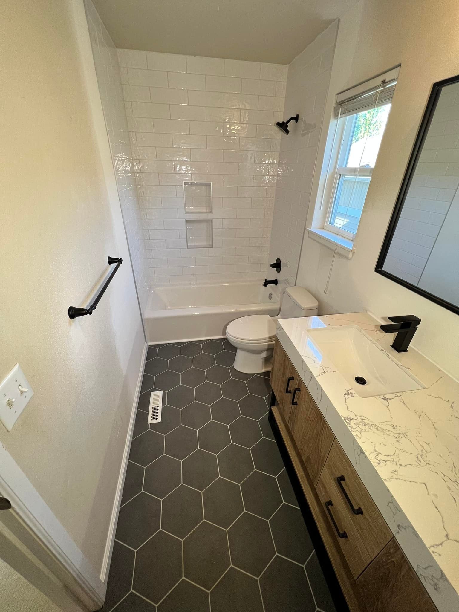 A bathroom with a toilet , sink , and shower.