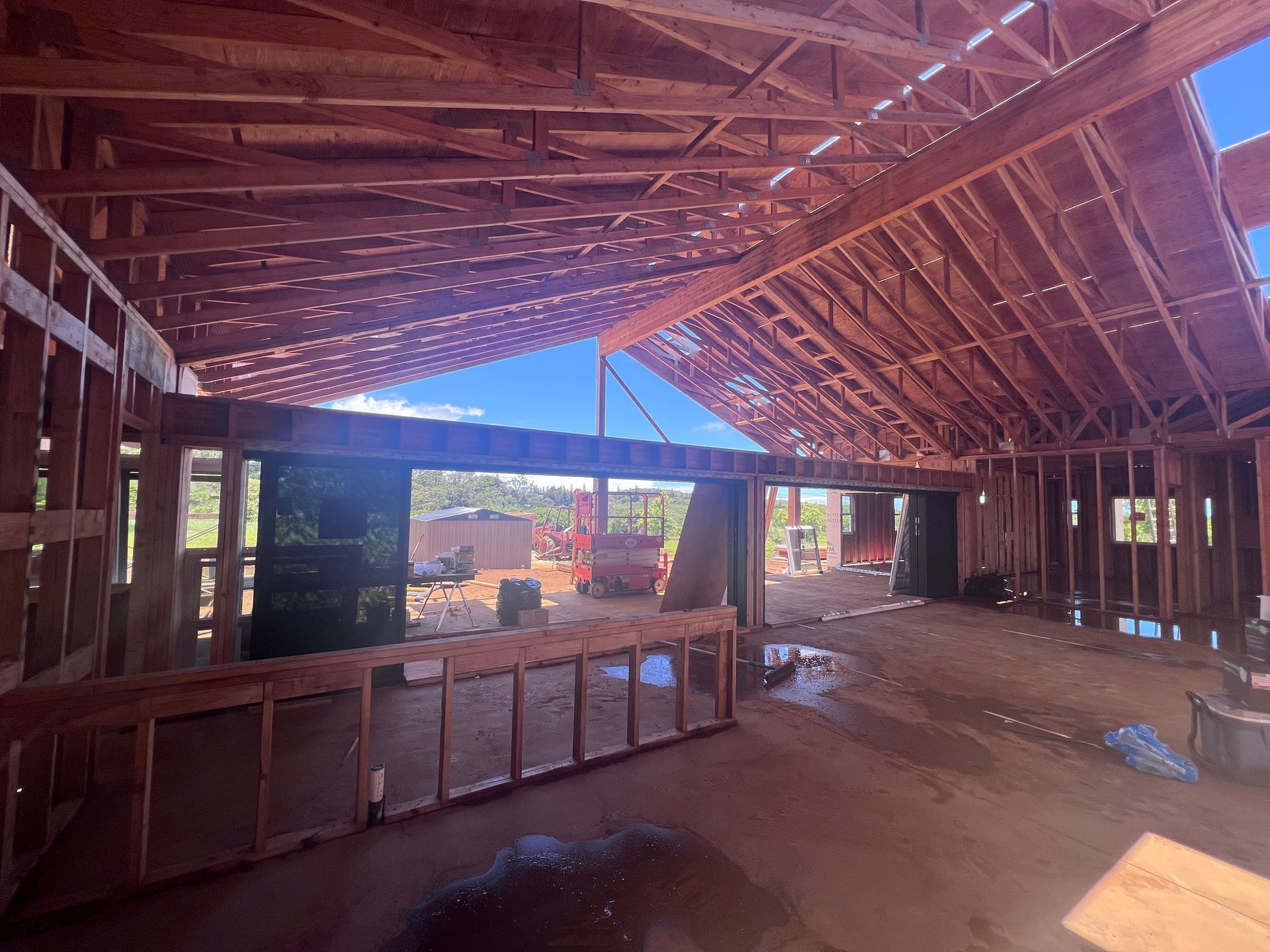 A wooden structure is being built in the middle of a dirt field.