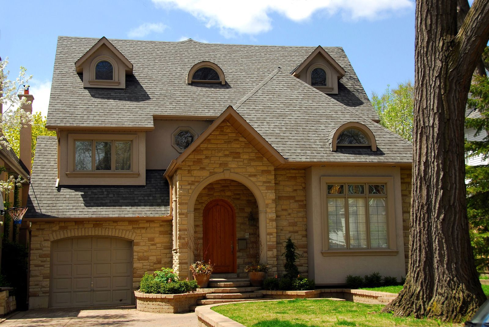 A house with a large tree in front of it