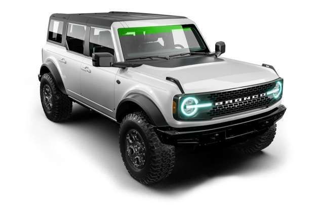 A blue tesla model s is on a black background.